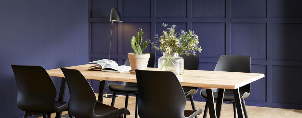 Plankebord med elegante spisestole med plastskal